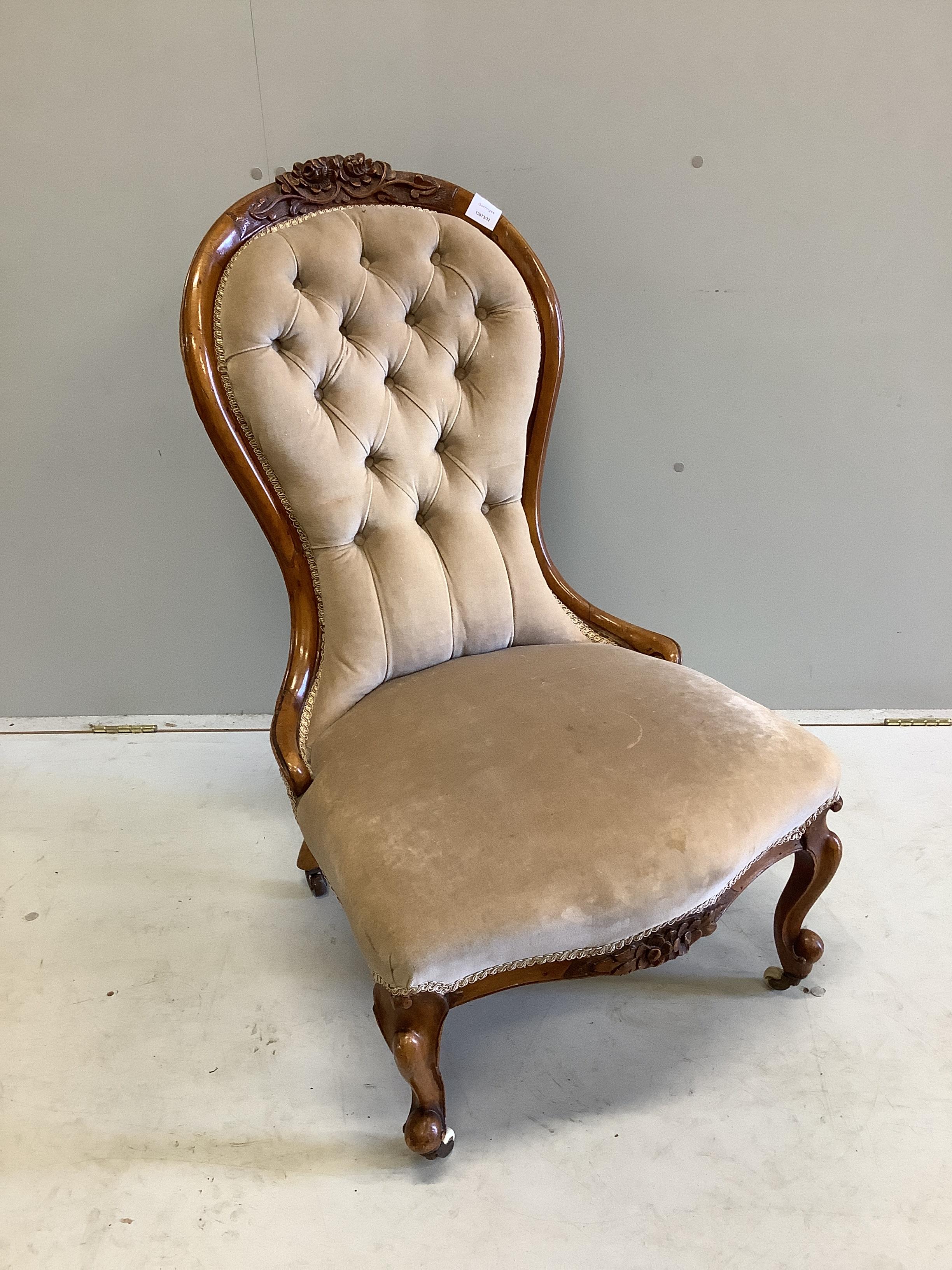 A Victorian walnut spoon back nursing chair, height 92cm